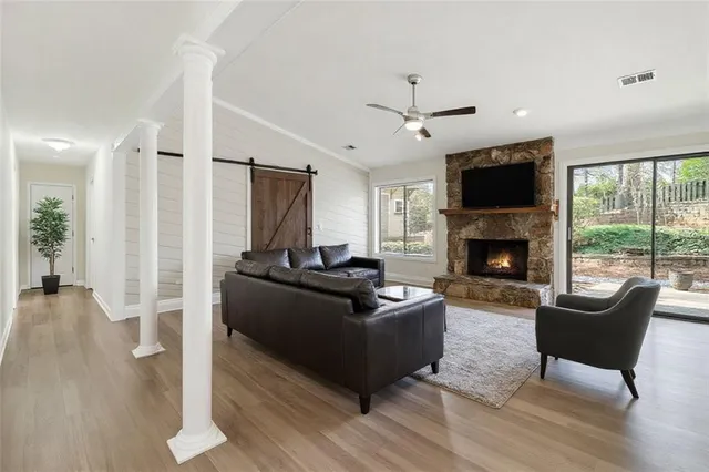 a living room with furniture a flat screen tv and a fireplace