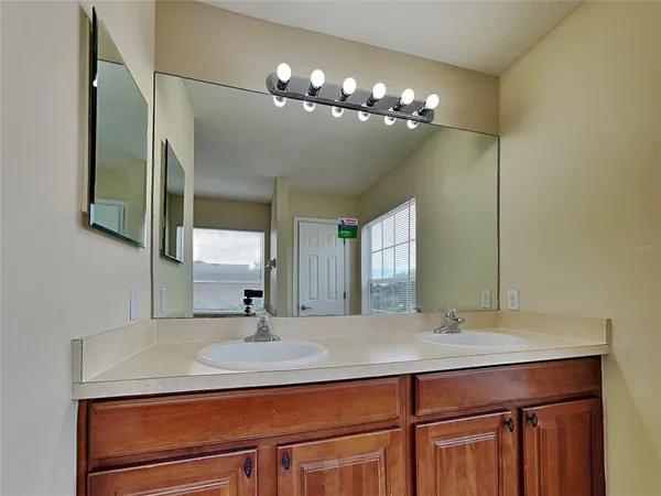 a bathroom with a sink double vanity and a mirror