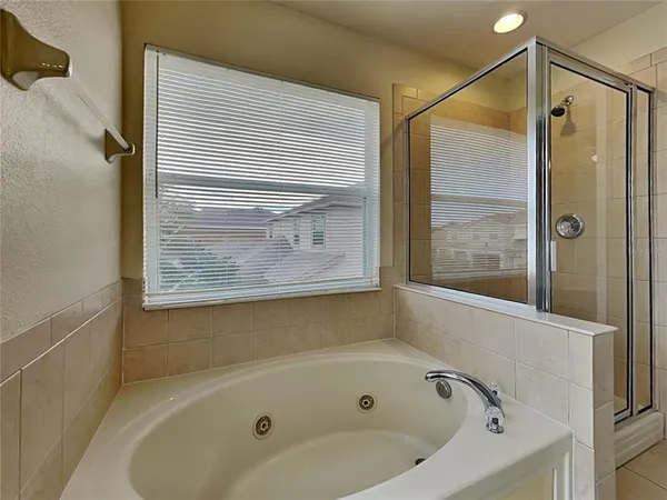 a bathroom with a tub and a shower