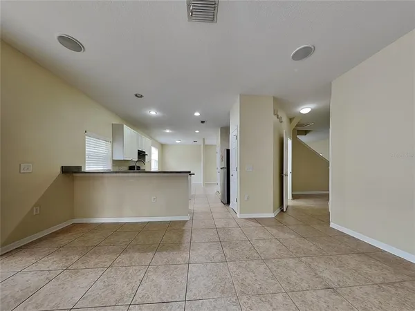a view of a kitchen with a refrigerator and a window