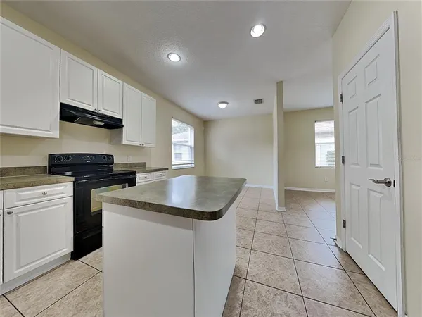 a kitchen with granite countertop a sink and cabinets