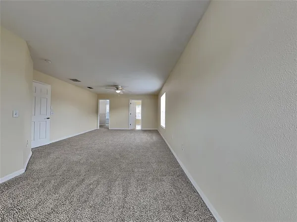 a view of a big room with closet and windows