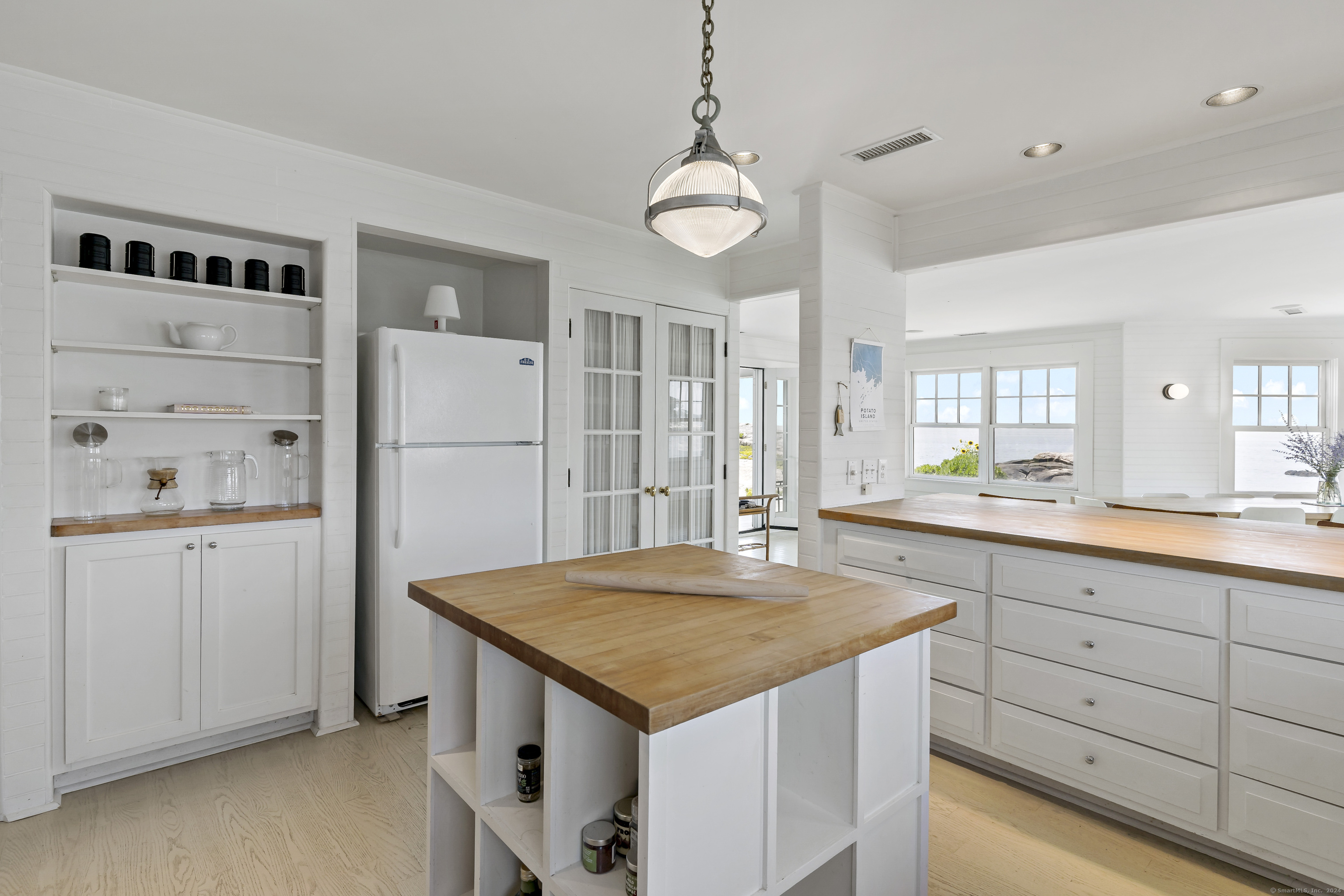 Potato Island Branford, CT 06405 - Photo 13 of 31 a kitchen with refrigerator cabinets and wooden floor