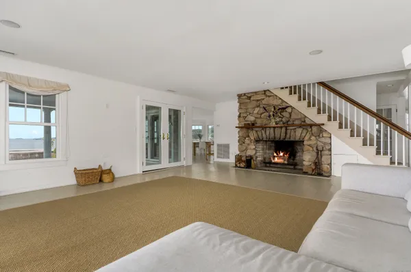 a view of a livingroom with wooden floor and a fireplace