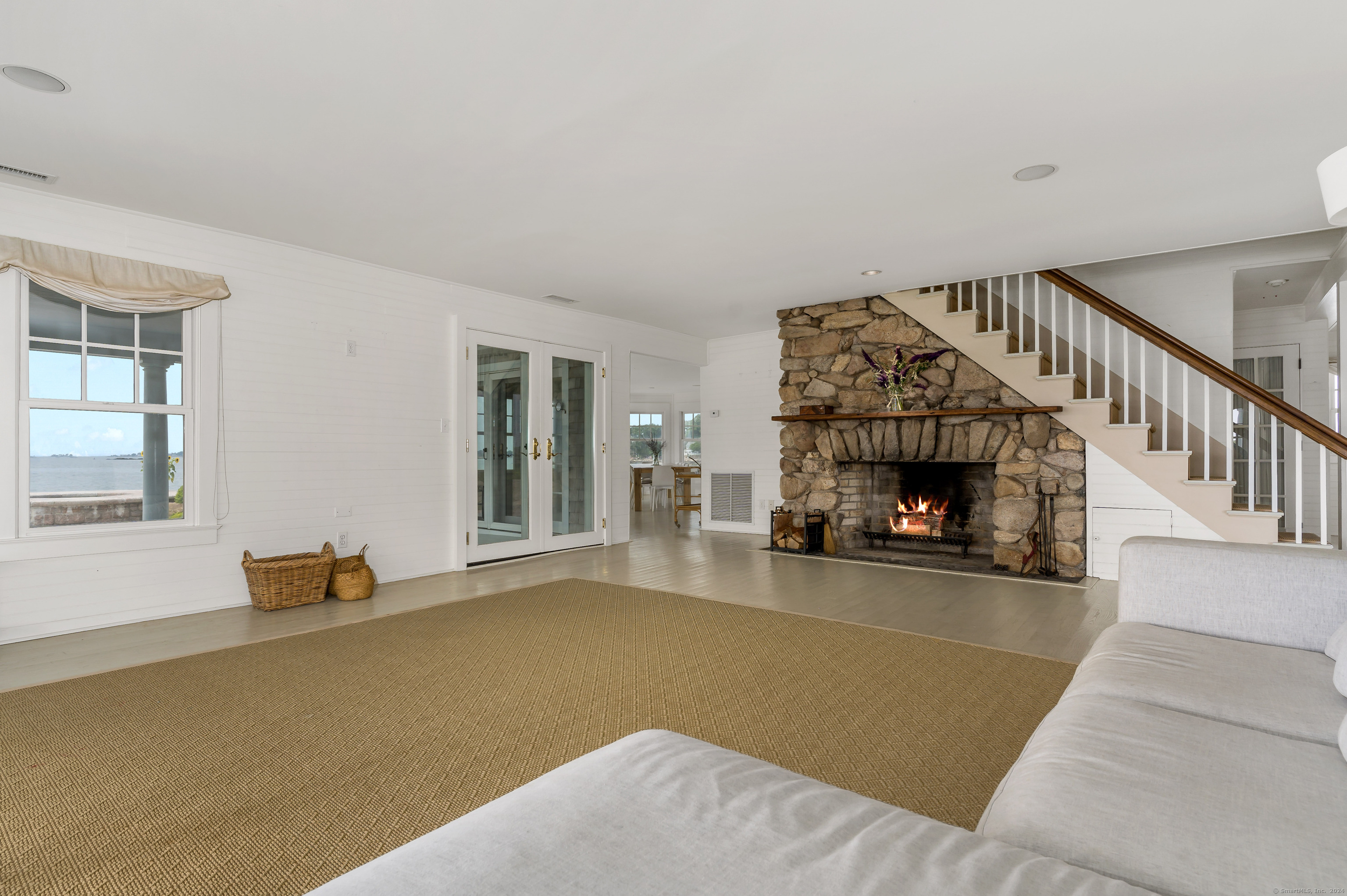 Potato Island Branford, CT 06405 - Photo 14 of 31 a view of a livingroom with wooden floor and a fireplace