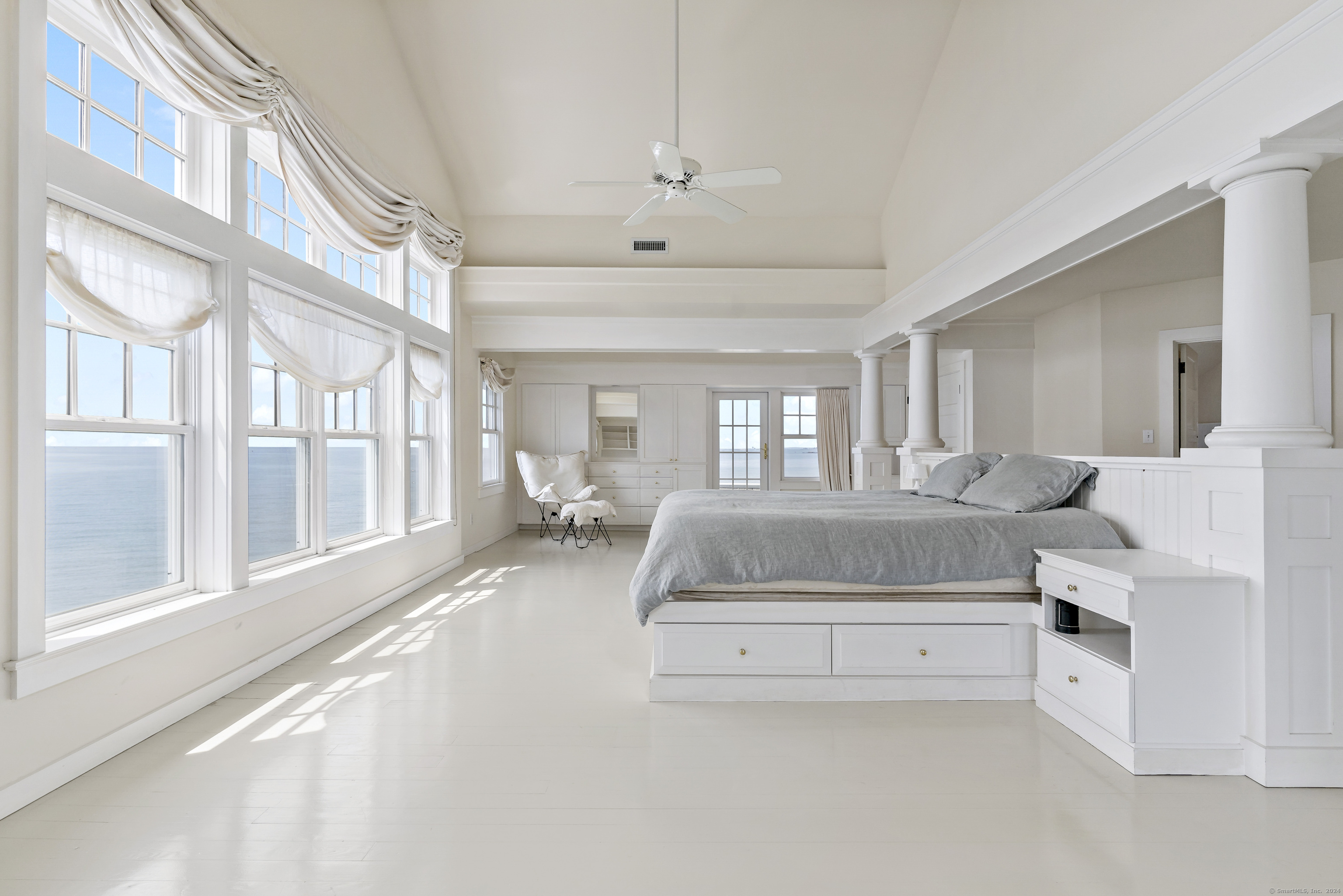 Potato Island Branford, CT 06405 - Photo 16 of 31 a spacious bedroom with a large bed and a chandelier