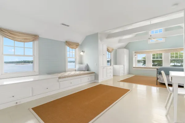a spacious bathroom with a tub sink and mirror