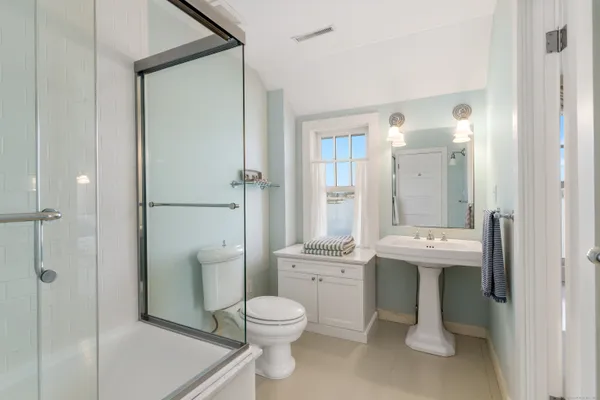 a bathroom with a toilet sink and shower
