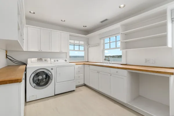 a utility room with sink dryer and washer