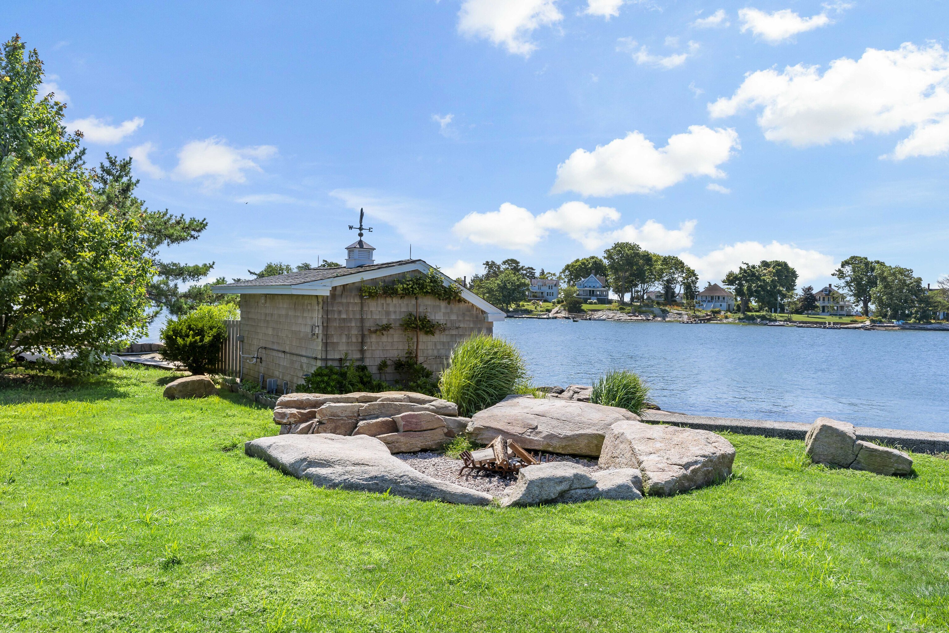 Potato Island Branford, CT 06405 - Photo 28 of 31 a view of a lake with lawn chairs and a fire pit