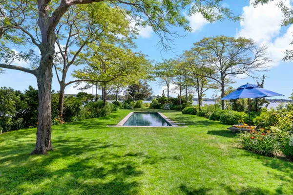 a view of a backyard with swimming pool