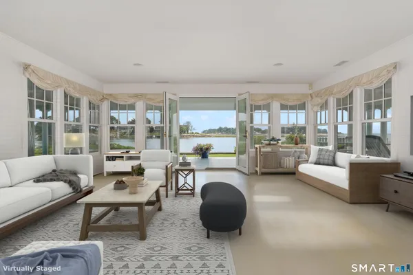 a living room with furniture and a large window