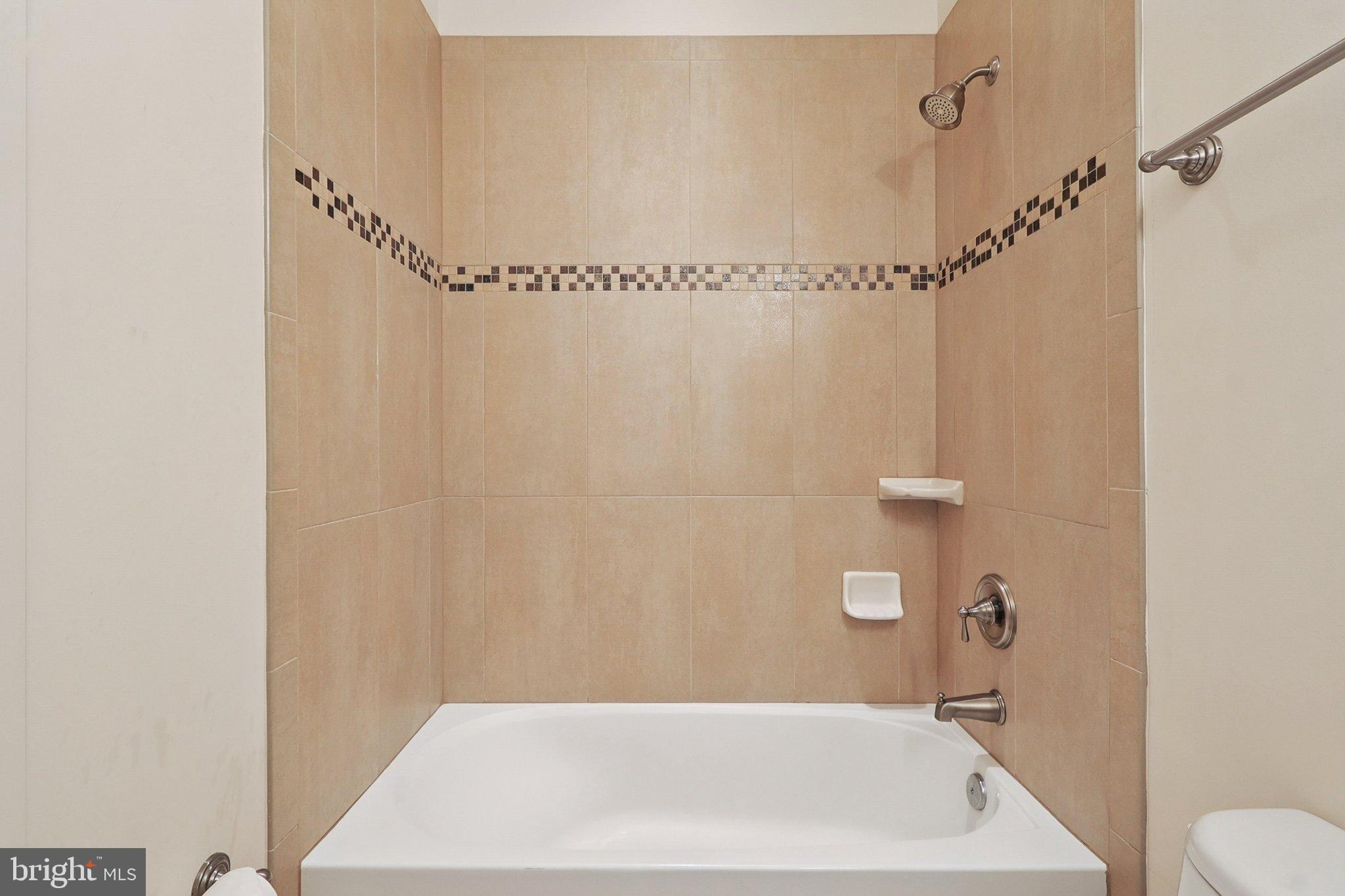 3211 Courtside Road Bowie, MD 20721 - Photo 61 of 108 Modern bathroom with elegant tile accents.
