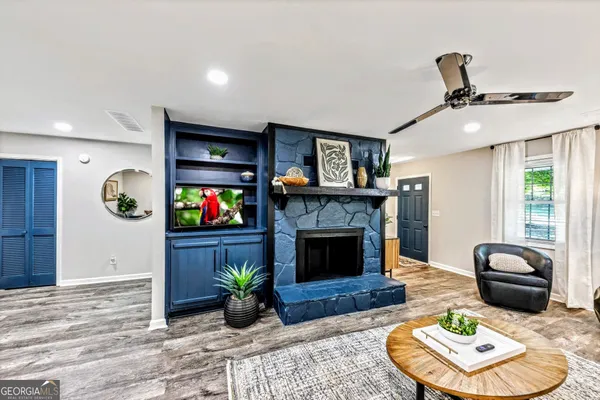 a living room with furniture and a fireplace