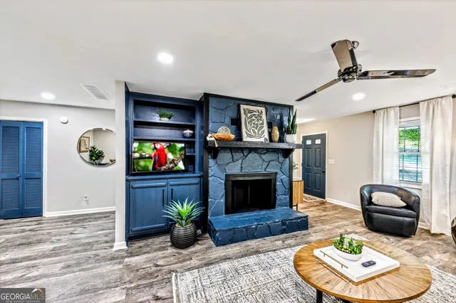 a living room with furniture and a fireplace