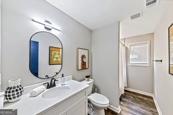 a bathroom with a toilet a sink and mirror
