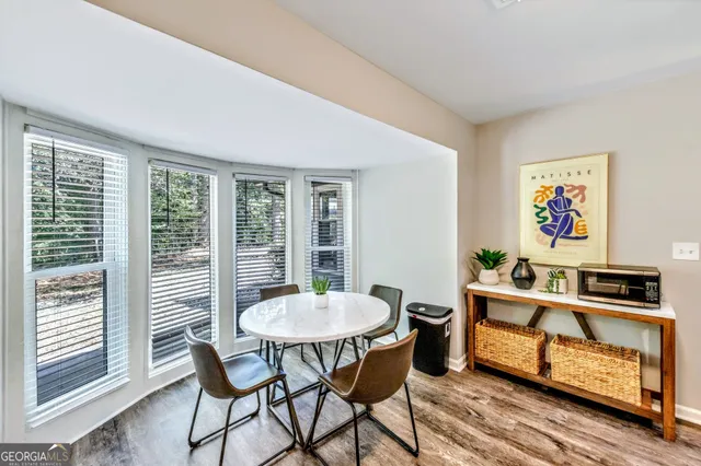 a view of a dining room with furniture window and wooden floor