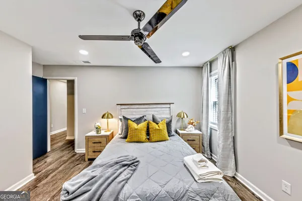 a bedroom with a bed and wooden floor