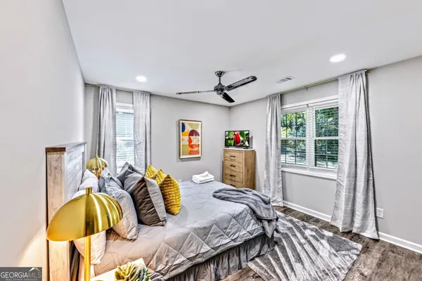 a bedroom with a bed and wooden floor