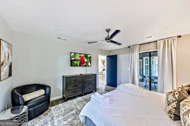 a bedroom with a bed and a television