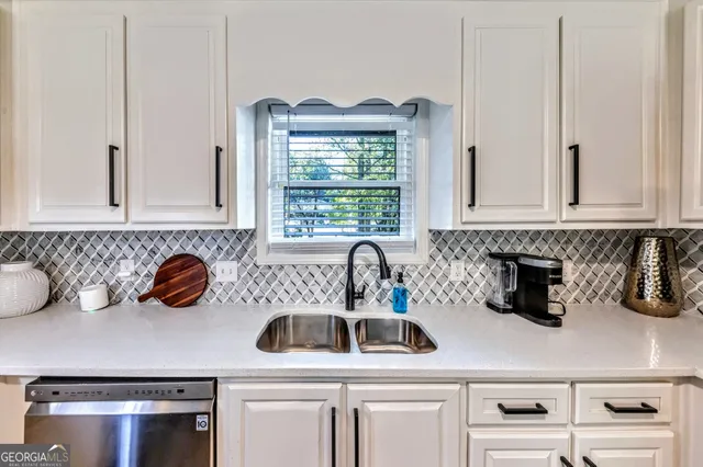 a kitchen with a sink a stove and cabinets