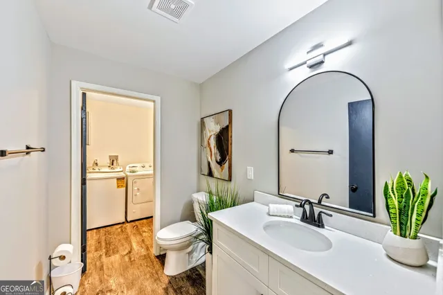 a bathroom with a granite countertop sink toilet and shower