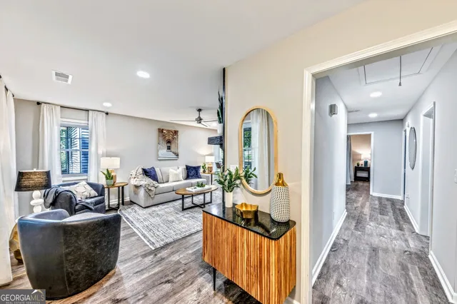 a living room with furniture and a wooden floor