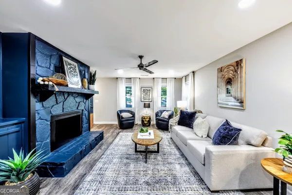 a living room with furniture and a fireplace