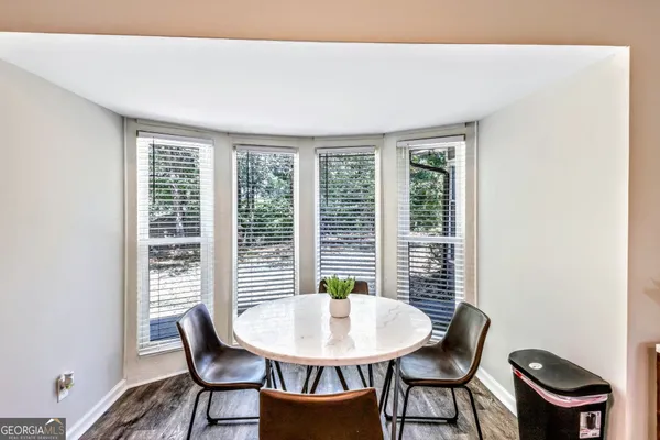 a view of a dining room with furniture and a potted plant