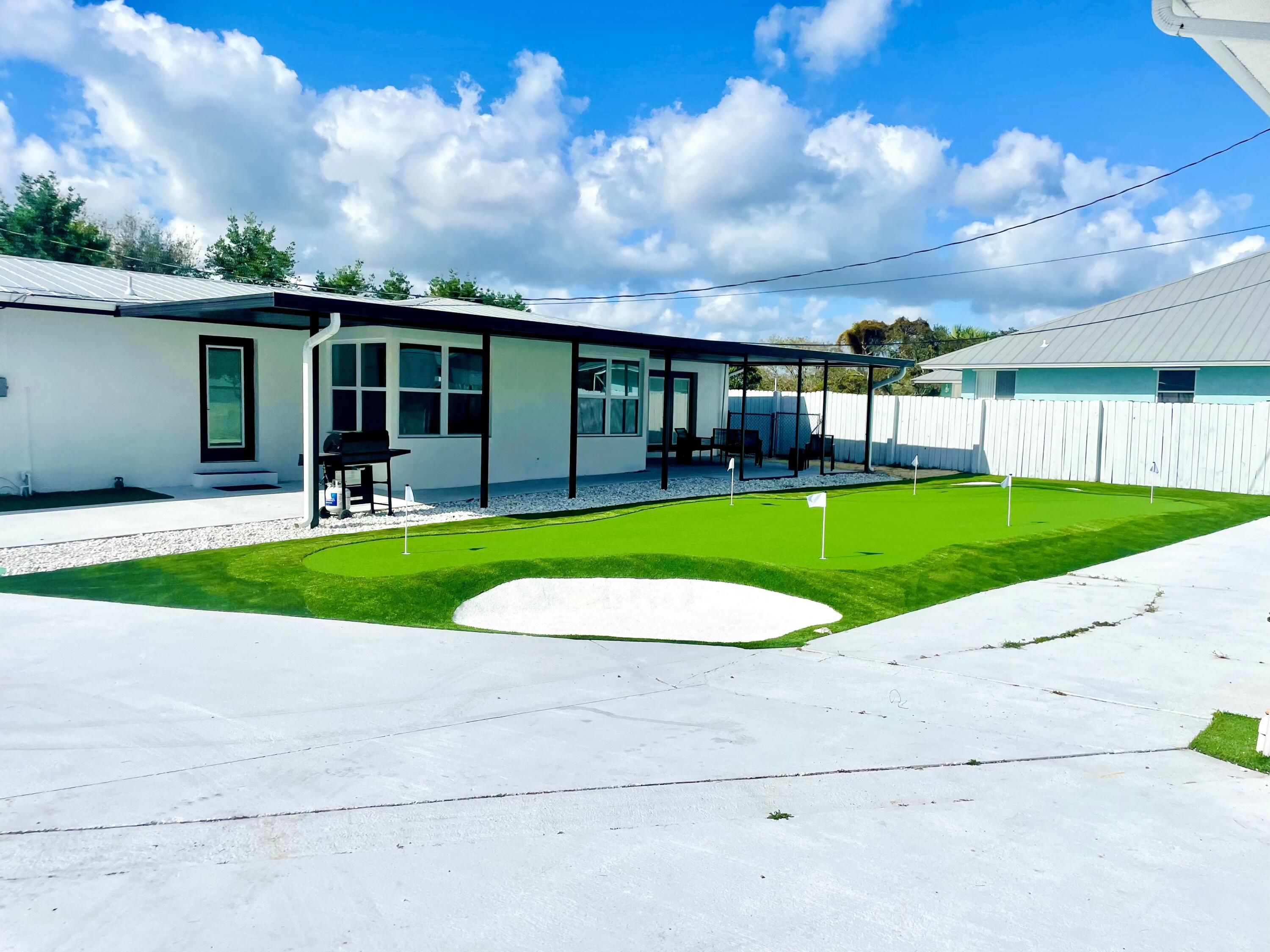 12994 Southeast Papaya Street Hobe Sound, FL 33455 - Photo 33 of 39 back covered Patio