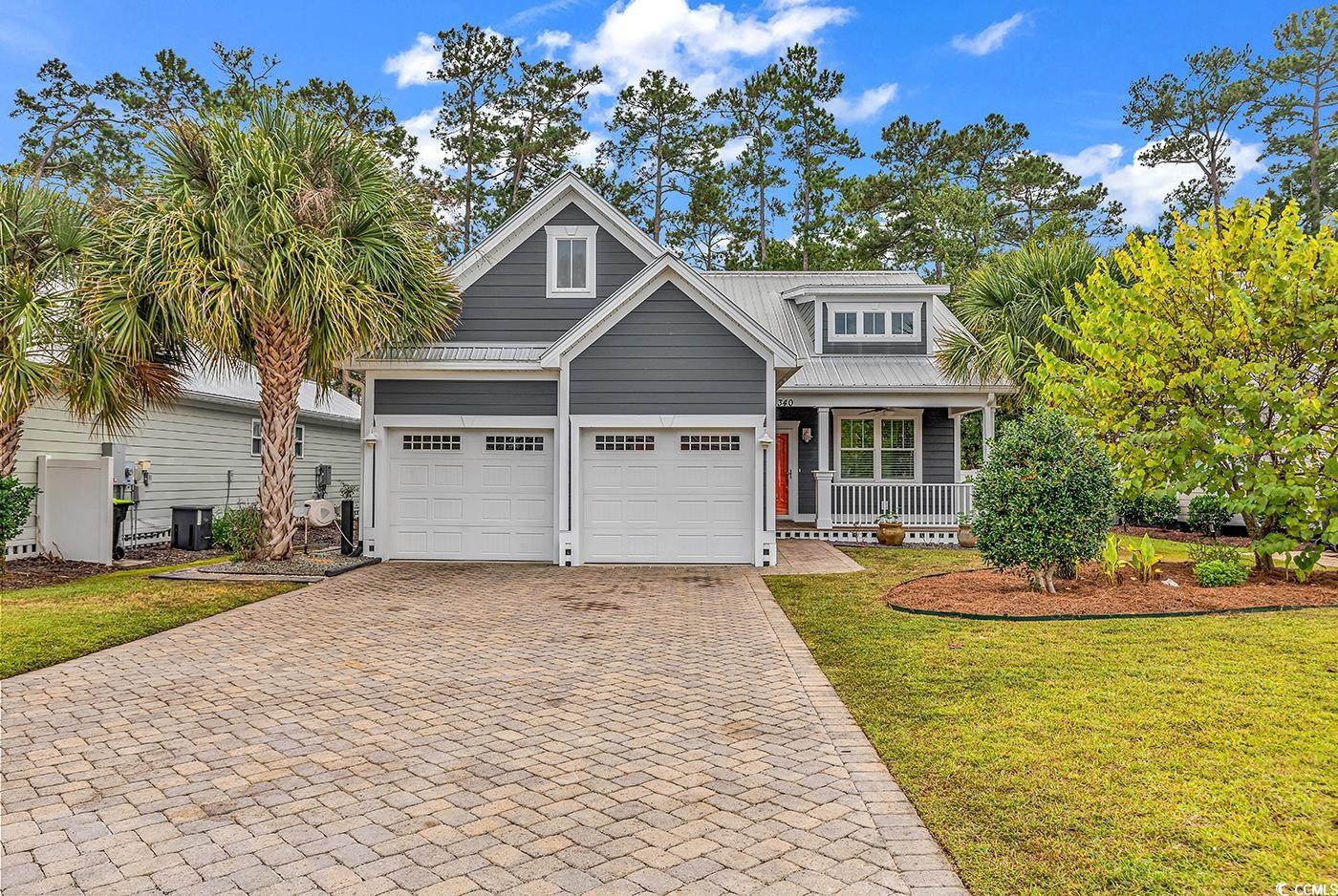 340 Waties Drive Murrells Inlet, SC 29576 - Photo 1 of 38 Craftsman Style One Story home featuring a paver stone driveway, a porch, a metal roof, and a two car garage.