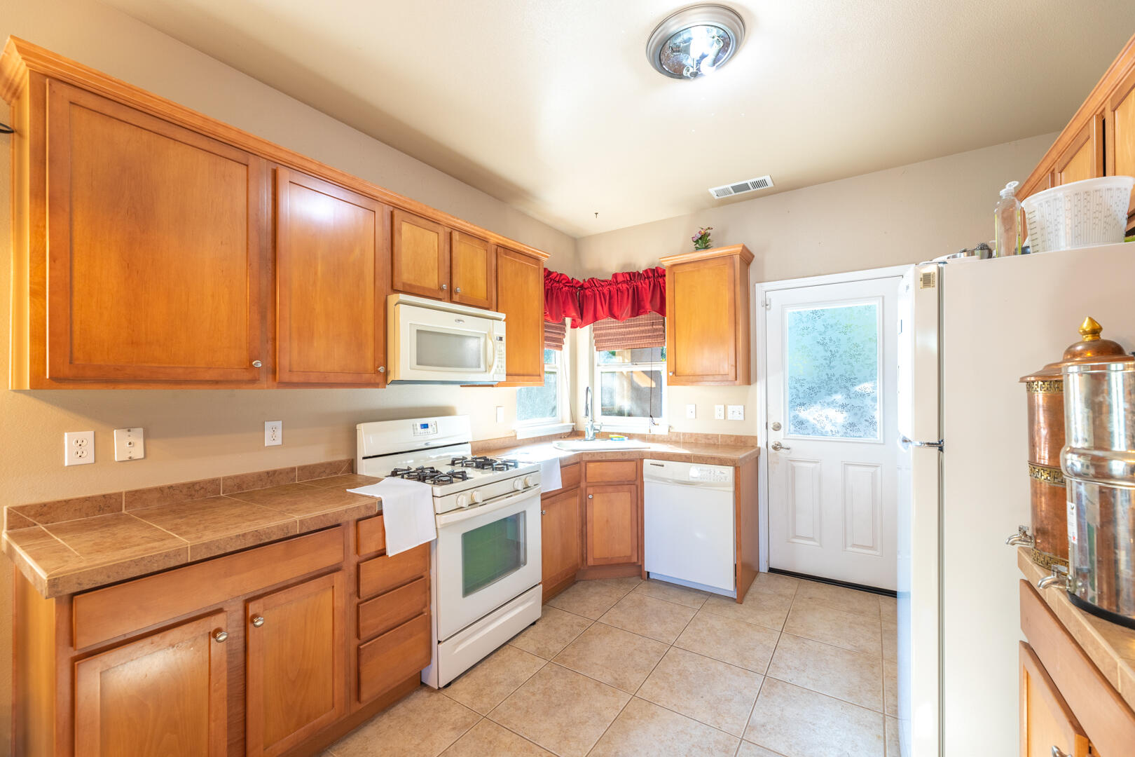 5442 Cedars Road Redding, CA 96001 - Photo 3 of 11 a kitchen with a sink stove and refrigerator