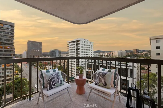 a view of a balcony with two chairs and a table