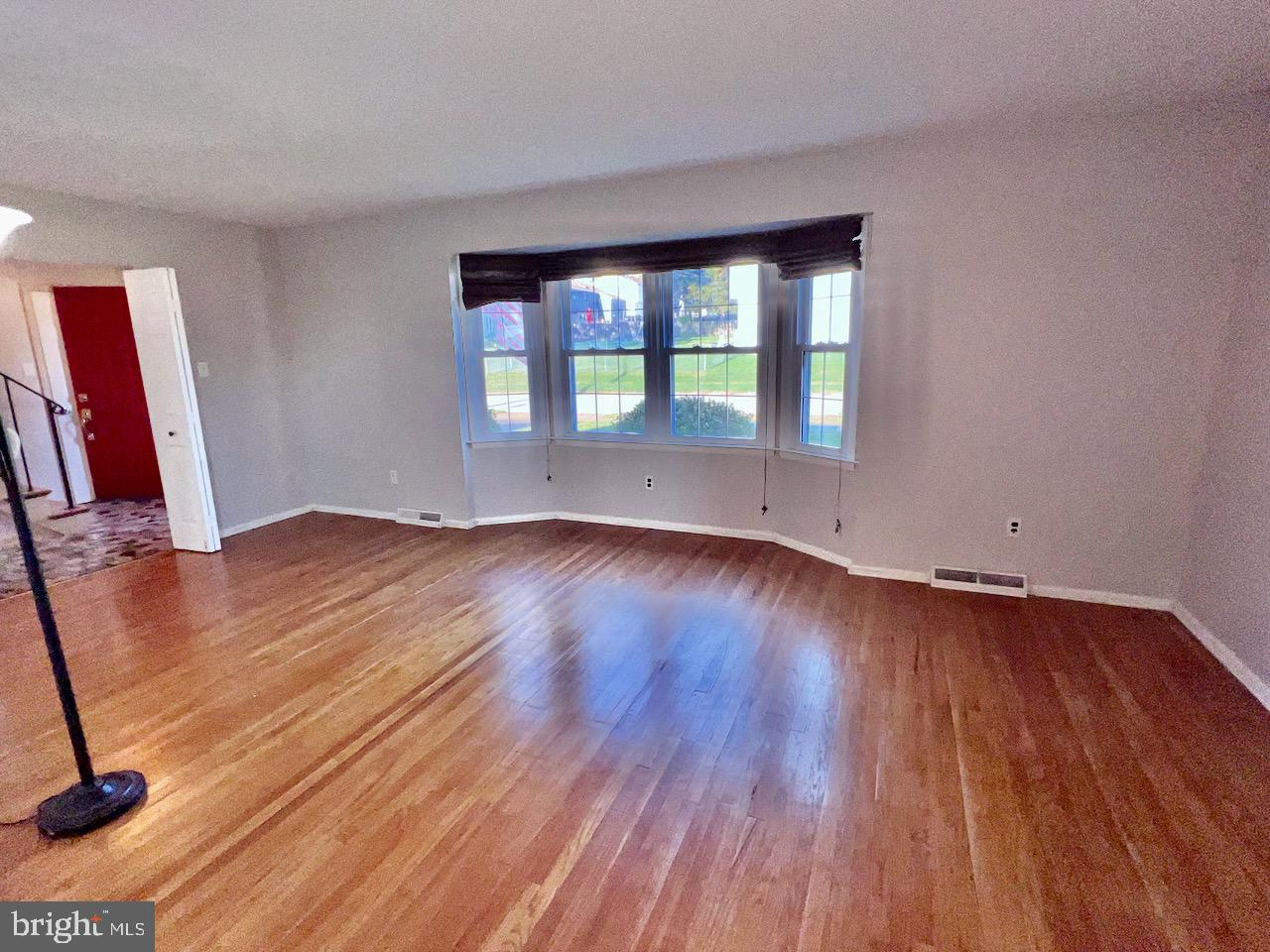 918 Rockwell Road Wilmington, DE 19810 - Photo 17 of 80 a view of an empty room with wooden floor and a window