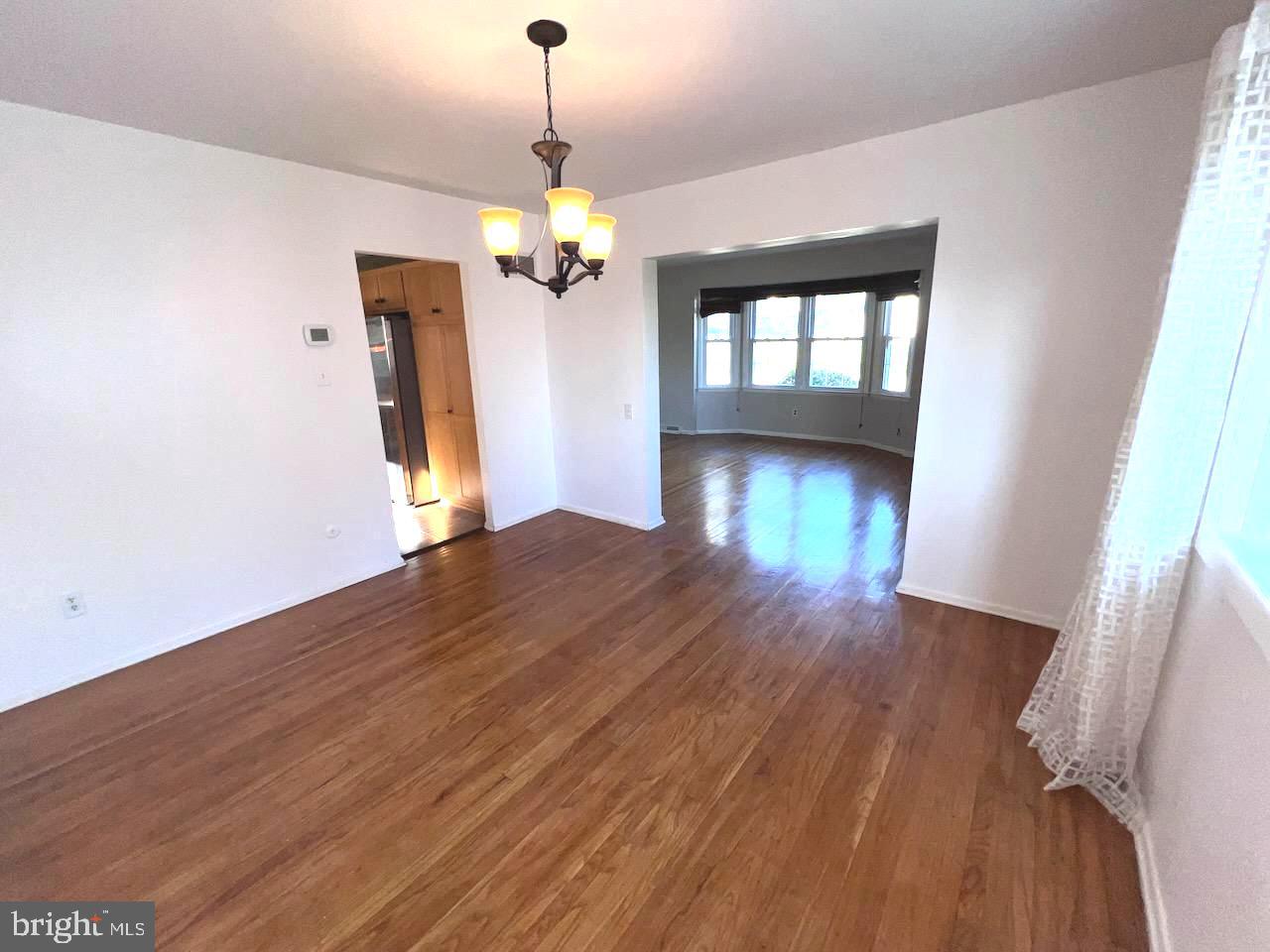 918 Rockwell Road Wilmington, DE 19810 - Photo 21 of 80 a view of empty room with wooden floor and chandelier