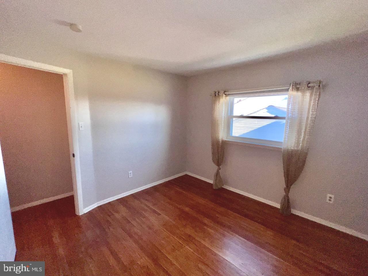 918 Rockwell Road Wilmington, DE 19810 - Photo 43 of 80 an empty room with wooden floor and windows