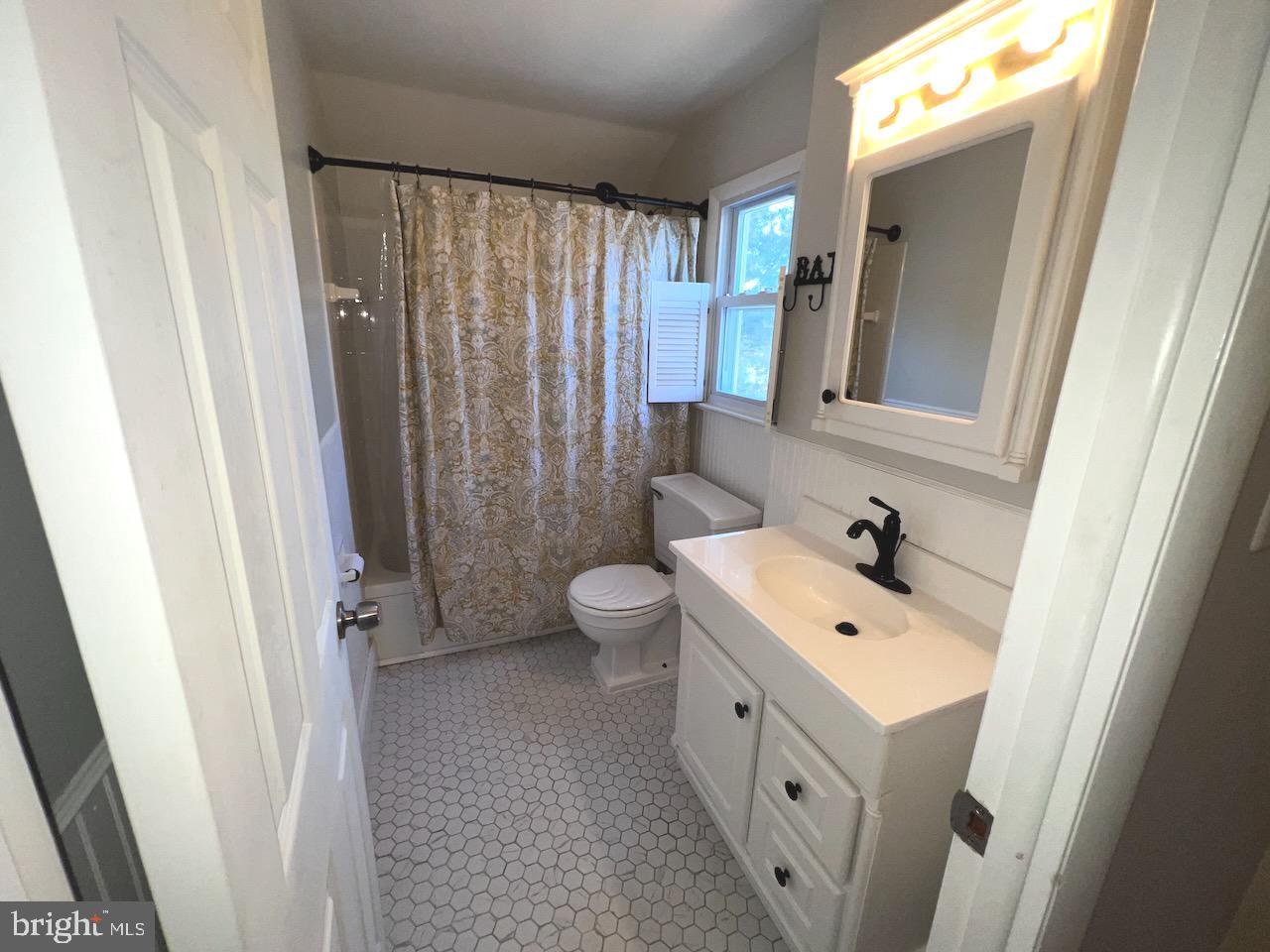 918 Rockwell Road Wilmington, DE 19810 - Photo 50 of 80 a spacious bathroom with a sink a toilet and a mirror