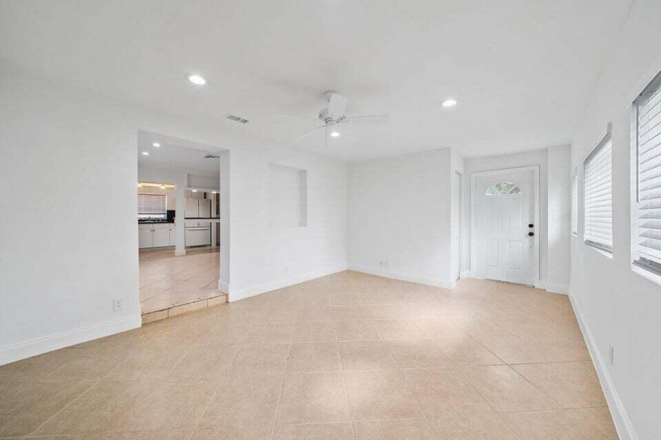 5889 Williamson Road Jupiter, FL 33458 - Photo 11 of 27 an empty room with kitchen and windows