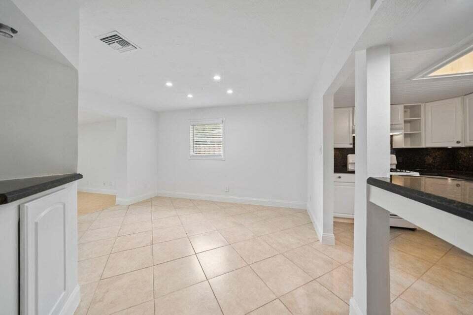 5889 Williamson Road Jupiter, FL 33458 - Photo 13 of 27 a kitchen with granite countertop a sink and a stove top oven