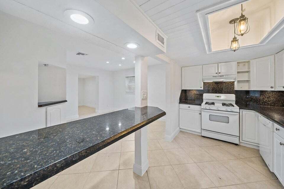 5889 Williamson Road Jupiter, FL 33458 - Photo 16 of 27 a kitchen with granite countertop a sink stainless steel appliances and cabinets