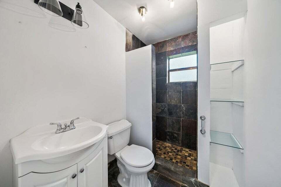 5889 Williamson Road Jupiter, FL 33458 - Photo 26 of 27 a bathroom with a sink toilet and shower