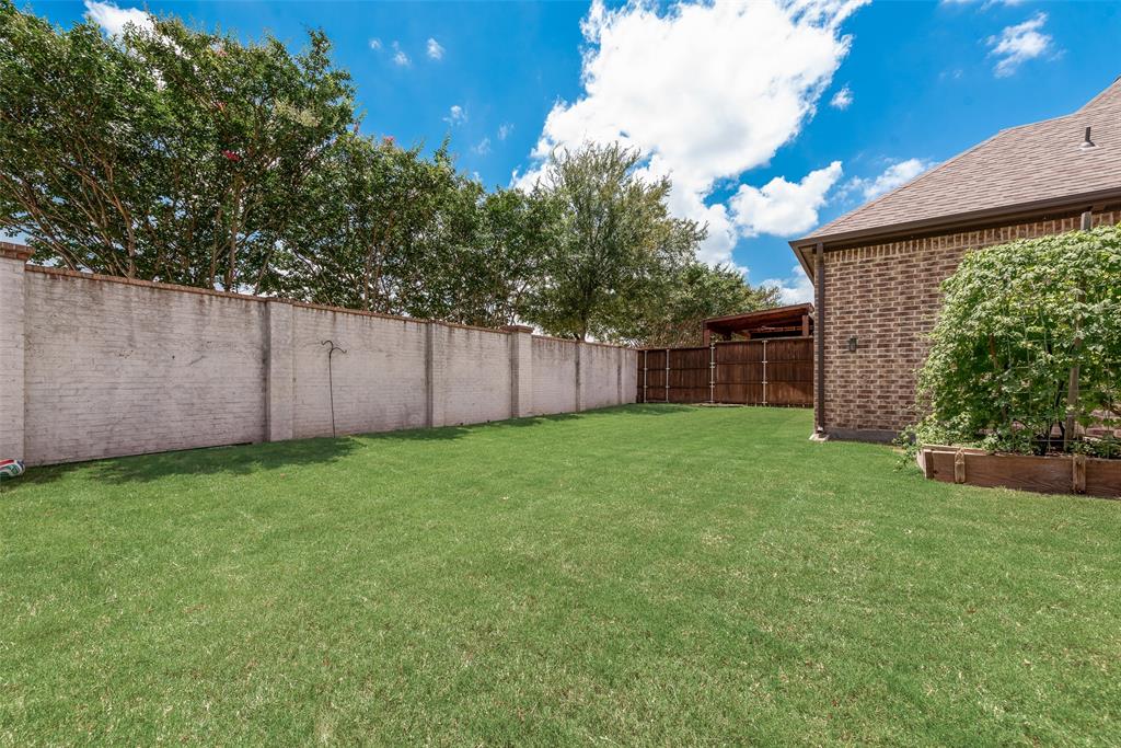 2021 Calisto Way Allen, TX 75013 - Photo 34 of 34 Expansive green lawn framed by a concrete block wall and mature trees