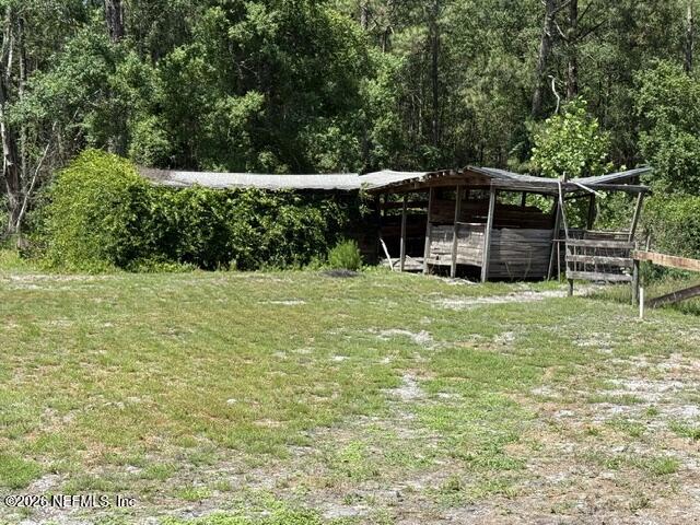 5214 Carter Spencer Road Middleburg, FL 32068 - Photo 10 of 50 a view of a chair and table on the green field