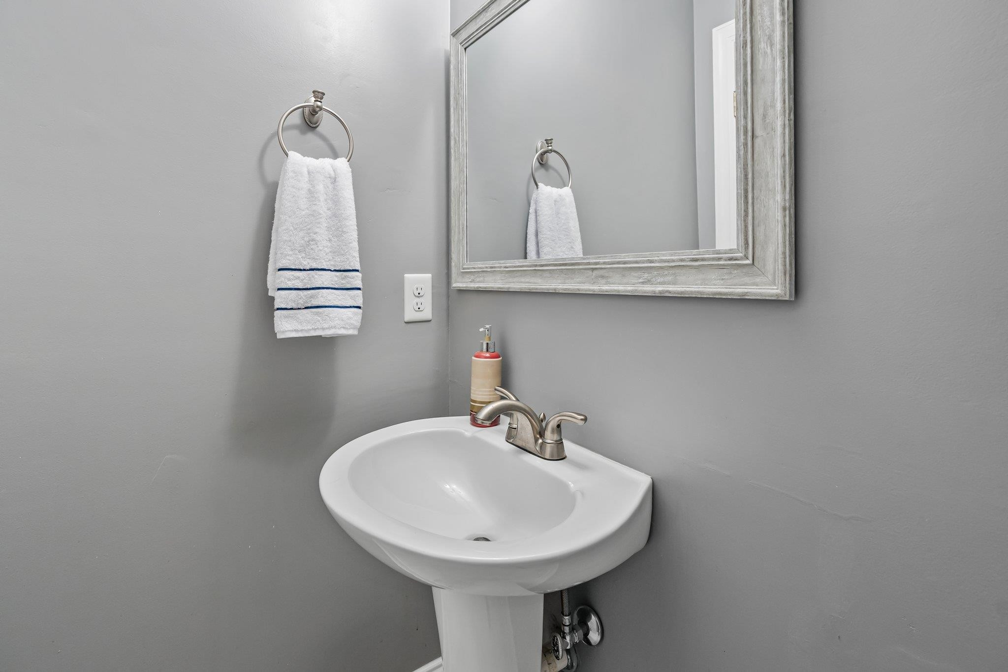 4918 Highgate Drive Durham, NC 27713 - Photo 23 of 44 a bathroom with a sink and a mirror