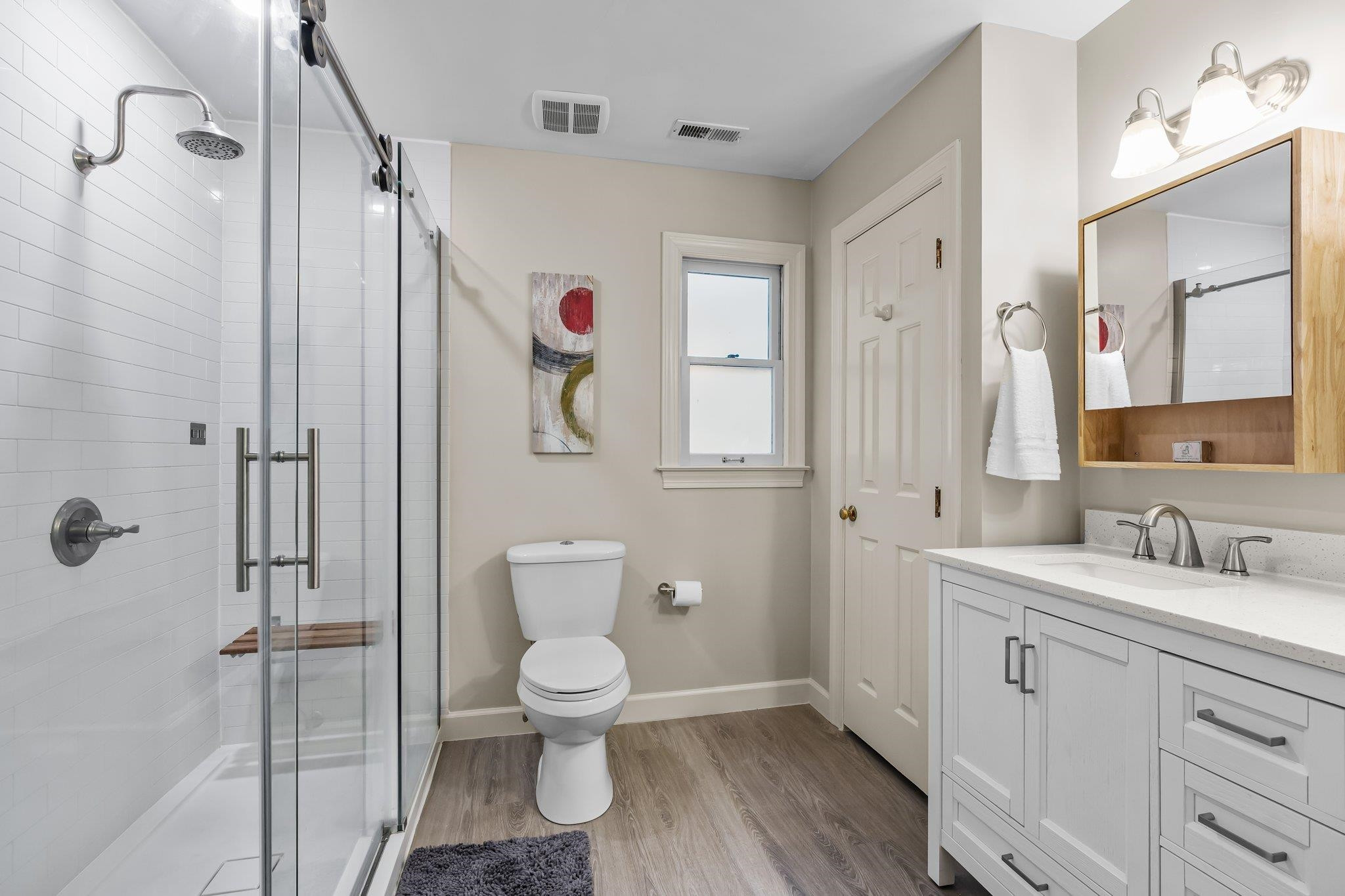 4918 Highgate Drive Durham, NC 27713 - Photo 28 of 44 a bathroom with a toilet a sink and a mirror