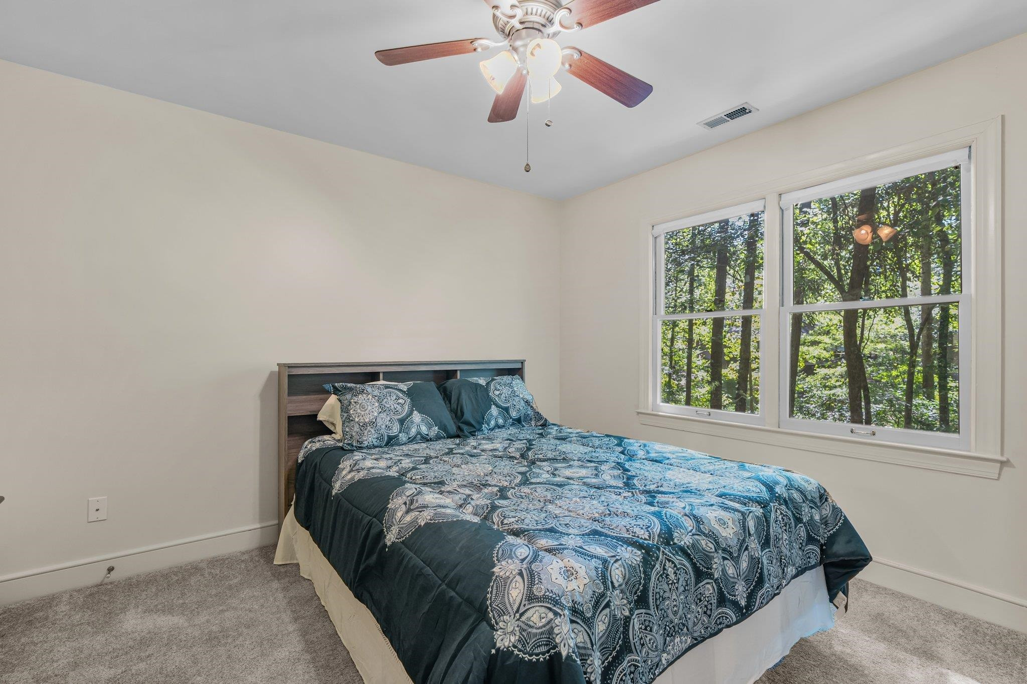4918 Highgate Drive Durham, NC 27713 - Photo 32 of 44 a bed sitting in a bedroom next to a window