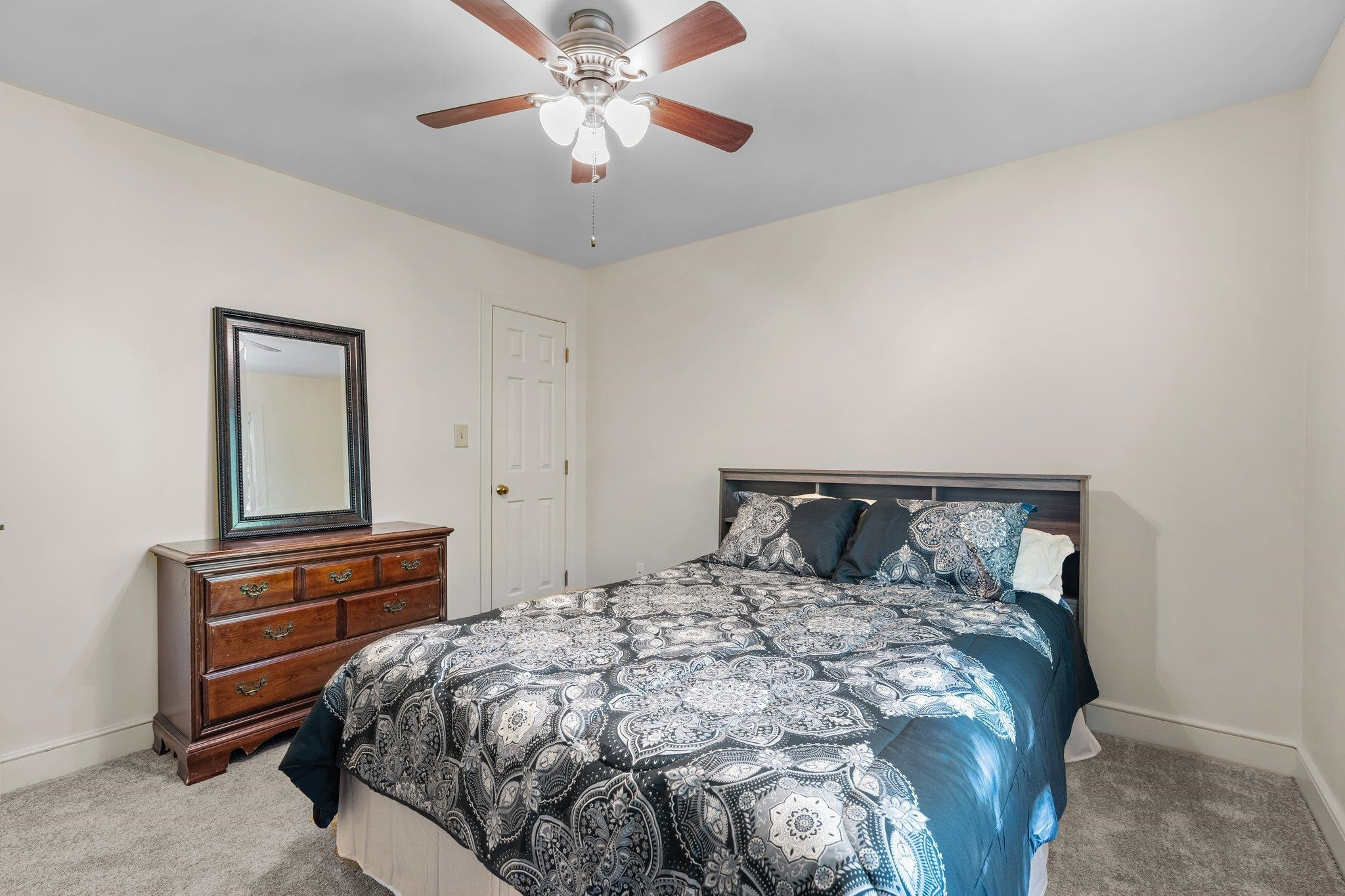 4918 Highgate Drive Durham, NC 27713 - Photo 33 of 44 a bedroom with a bed and a chandelier