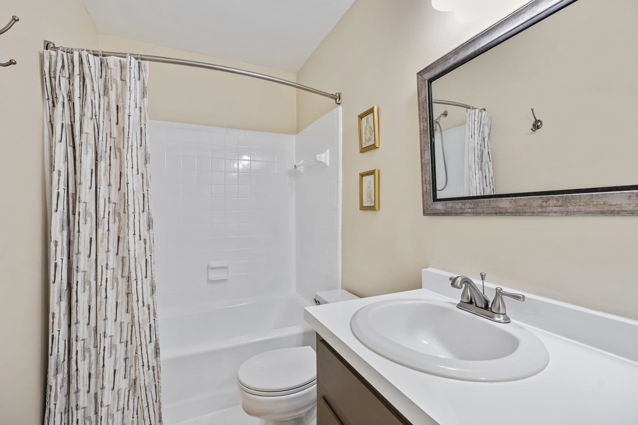 4918 Highgate Drive Durham, NC 27713 - Photo 34 of 44 a bathroom with a sink a toilet and shower curtain