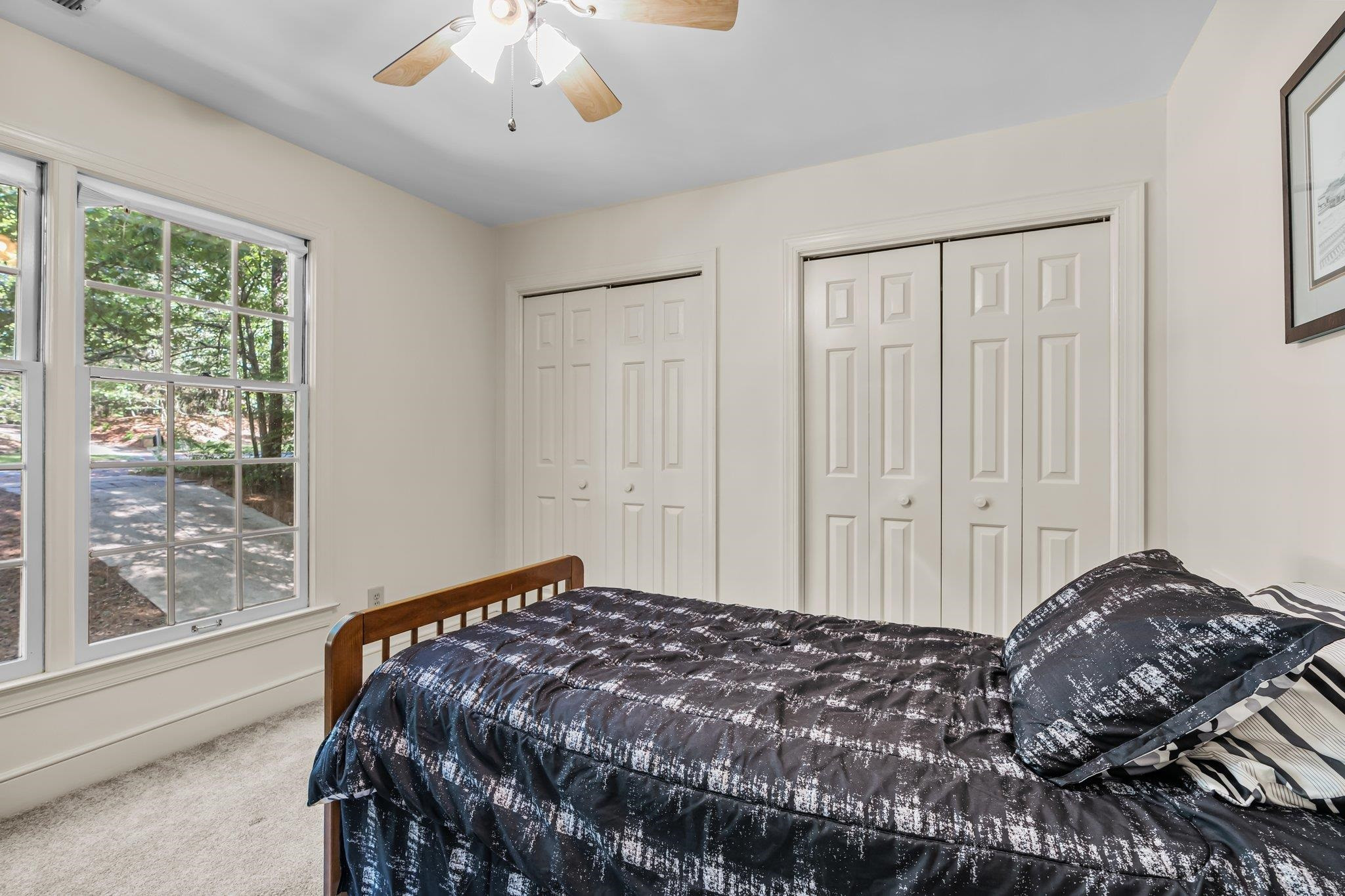 4918 Highgate Drive Durham, NC 27713 - Photo 36 of 44 a bedroom with a large bed and a chandelier