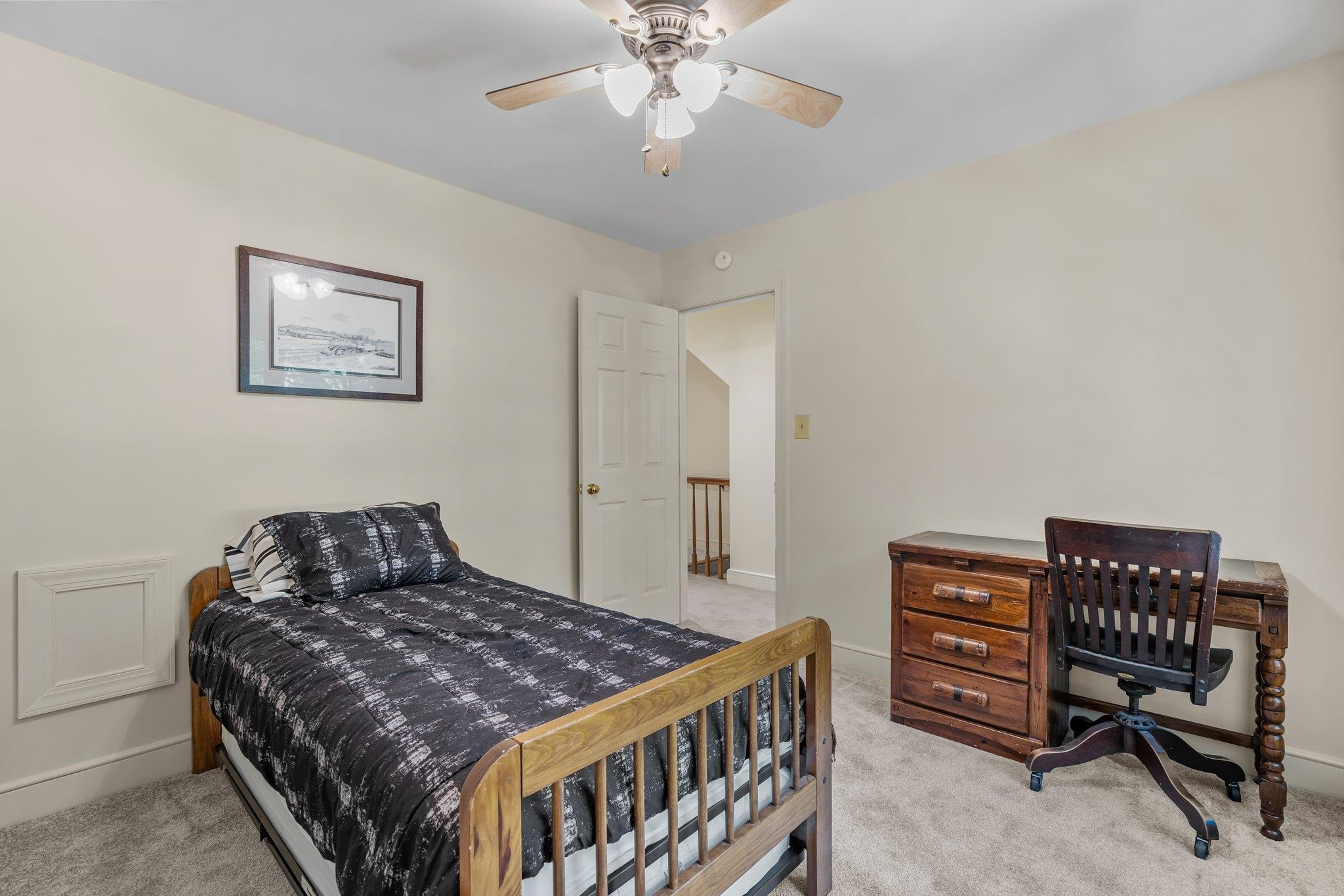 4918 Highgate Drive Durham, NC 27713 - Photo 37 of 44 a bedroom with a bed a dresser and a chandelier